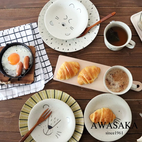 Mogu Mogu 萌萌動物餐盤2入組，包含兩個陶瓷餐盤，一個印有可愛獅子臉圖案，黃色條紋裝飾；另一款為白色，印有熊貓臉圖案，點狀裝飾。