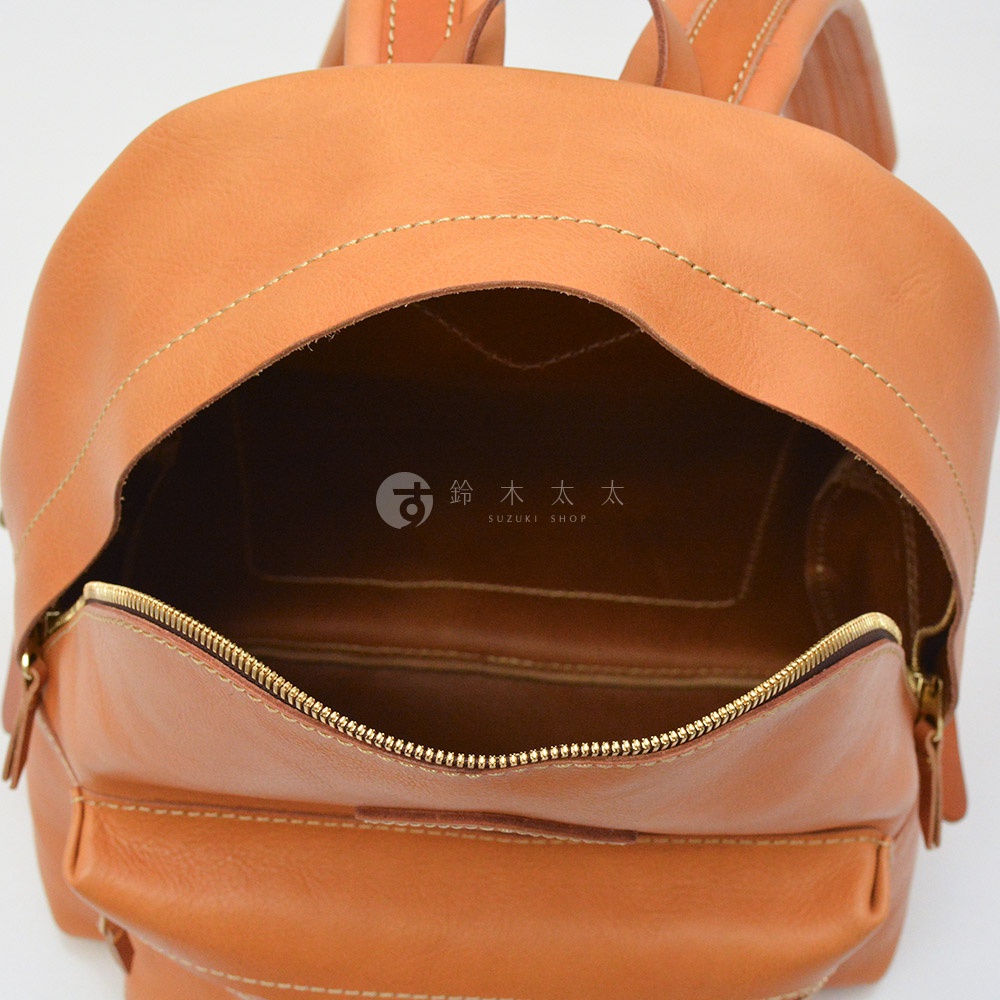 職人手作皮革休閒風後背包 R-93，展示內部空間，採用淺棕色光滑皮革製成，配有金色拉鍊和米白色縫線。