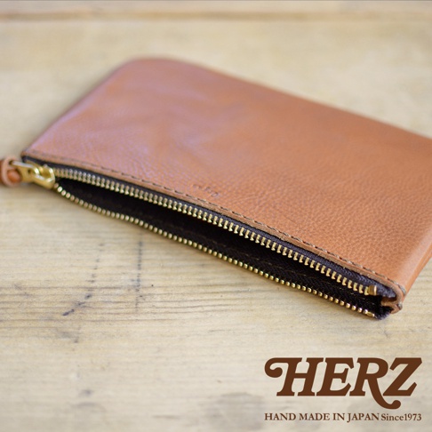 棕色皮革拉鍊式小物收納袋，拉鍊為金色，袋身紋理細緻。