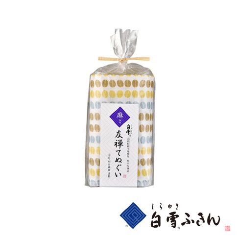 友禪染廚房兩用長拭巾，以棉麻材質製成，點綴著米白、黃、藍色系的圓點圖案，由透明塑膠袋綑綁包裝，包裝上印有紫色菱形標誌及日文產品名稱。