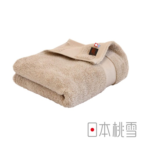 米色今治匹馬棉浴巾，質地柔軟，邊緣有品牌標籤。