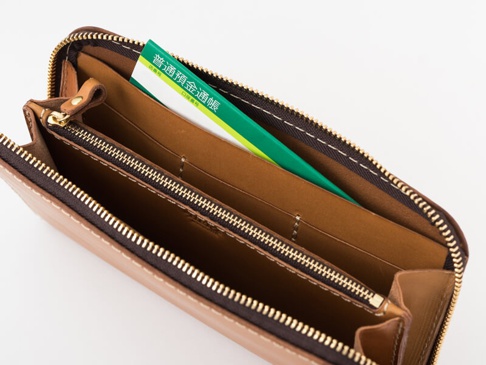 職人手作皮革大容量拉鍊長夾 (WL-5)，淺棕色皮革，內部隔層清晰，有拉鍊零錢袋，並置入一本綠色封面存摺。