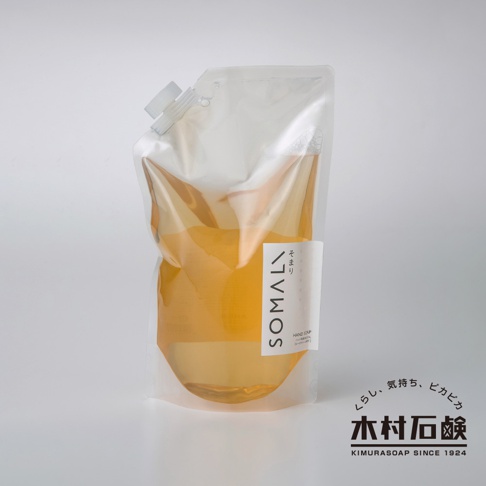 透明軟袋裝的 SOMALI 洗手液體皂，內容物呈琥珀色，袋口有白色塑膠瓶蓋。標籤上印有 SOMALI 字樣及日文標示。