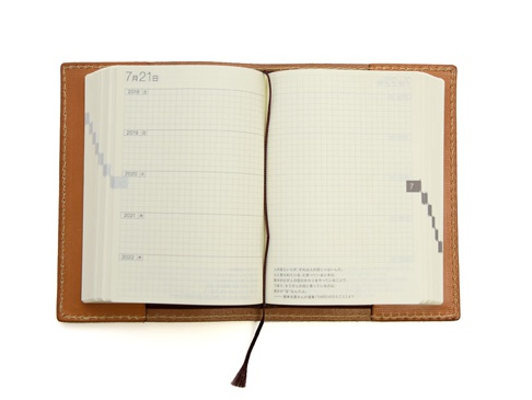 職人手作皮革厚革書套，M尺寸，採用棕色皮革材質，內含一本淺色網格內頁筆記本，附有書籤帶。