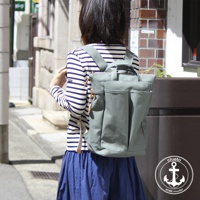 灰綠色高島帆布後背包，有兩個前置口袋和兩個側袋，採用簡約設計，適合日常攜帶。