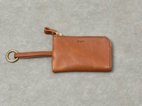 職人手作皮革Organ抽繩鑰匙包，焦糖棕色，採用柔軟的皮革材質，配有金色拉鍊、皮革拉環和金屬鑰匙圈。