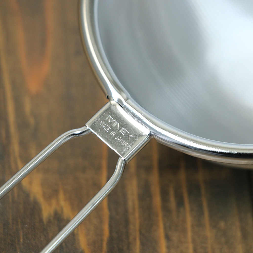 不鏽鋼超細目濾茶器，銀色，帶有 MINEX MADE IN JAPAN 標誌，置於木製背景上。