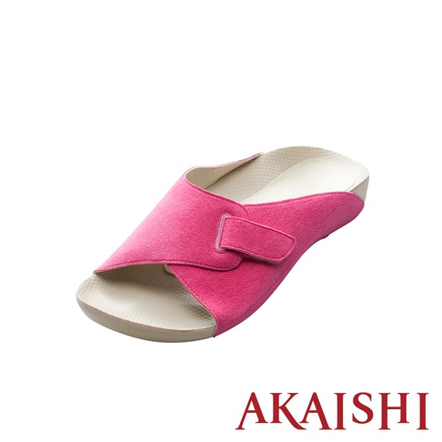 一隻桃紅色絨面材質的指壓室內拖鞋，鞋面有魔鬼氈可調整鬆緊，鞋墊為米白色，鞋底為淺棕色。