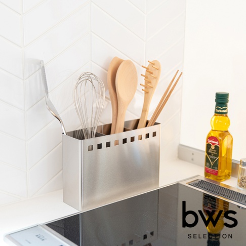 不鏽鋼製的可拆式餐具收納架，呈現銀色金屬光澤，內部分隔，收納著打蛋器、木勺、竹製義大利麵夾和一雙筷子。