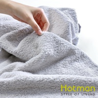 一條柔軟的灰色吸水乾髮巾，材質為絨毛，手部正在觸摸其蓬鬆的質地。