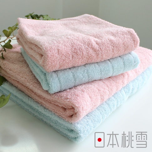 堆疊的今治超長棉毛巾，有柔和的粉紅色和淺藍色，材質柔軟，紋理清晰。
