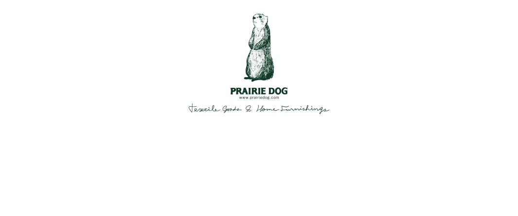 此圖片為 Prairie Dog 品牌的商標，中央繪有一隻佩戴墨鏡的草原犬鼠插畫，下方以深綠色字體標示品牌名稱與網址，並以草寫英文字體寫出 Textile Goods & Home Furnishings 的標語。