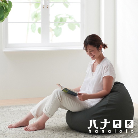 深灰色皮革懶骨頭沙發，一位女子正坐在上面閱讀。