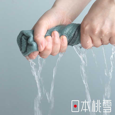 一雙手正用力擰乾一條藍綠色的日本桃雪今治輕量快乾運動長毛巾，水流從毛巾中湧出並向下流淌，畫面下方印有日本桃雪的品牌標誌與文字。