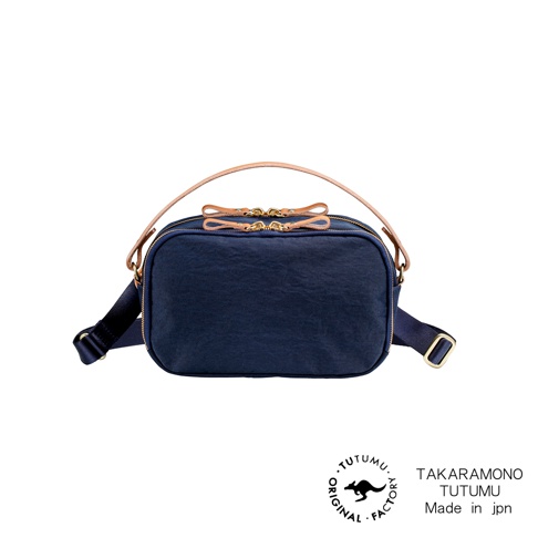 TUTUMU Rectangle 防潑水兩用斜背包，深藍色尼龍材質，附有米色皮革提把及肩帶，金色拉鍊與裝飾，底部有品牌標誌。