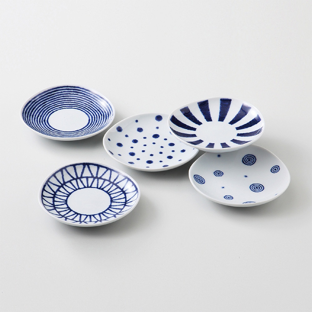 五件式波佐見燒醬料碟，以白色陶瓷為基底，飾有深藍色不同風格的紋飾，包括放射狀線條、圓點、同心圓及網格紋，造型精巧，適合盛裝醬料。