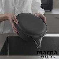 marna TOKYO 1872 品牌標誌，上方為一人手持深灰色洗濾盆，正將盆中的水瀝入水槽，水流清晰可見。