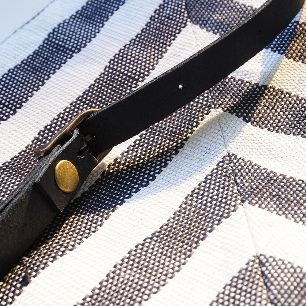 BAN INOUE 斑馬條紋麻布斜背包的黑色皮帶和金屬扣環特寫