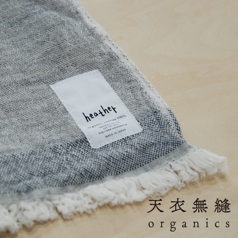 HEATHER有機混紡棉質感流蘇浴巾，素面，灰色調，帶有白色流蘇邊緣。產品上有品牌標籤，標明「organic cotton 100%」及「MADE IN JAPAN」。