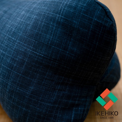 深藍色多功能紓壓骨頭枕，織物表面有細緻的格子紋理，枕頭呈現圓柱狀。