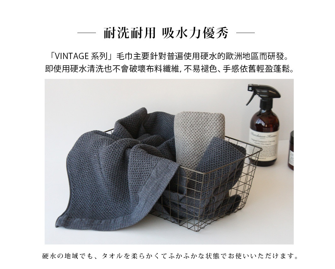 VINTAGE鬆餅紋棉麻混紡毛巾，深灰色與淺灰色，材質為棉麻混紡，質地柔軟，紋理清晰，置於金屬籃中。