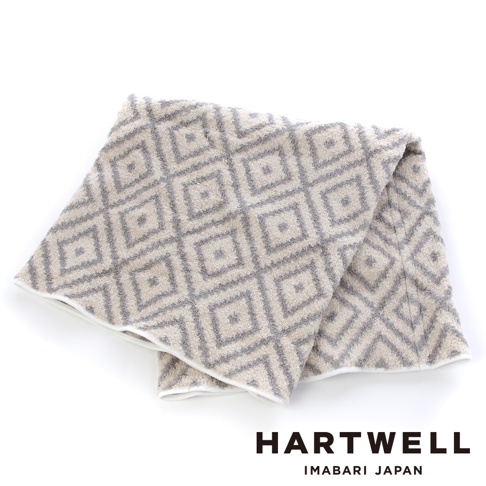 今治柔彈伸縮美肌枕套，米白色織物印有灰色菱形格紋，材質柔軟，邊緣有白色滾邊。