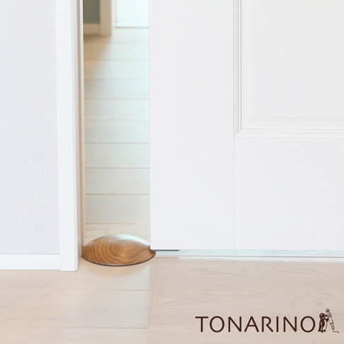 天然實木製成的圓弧形門擋，木紋清晰，呈淺棕色，放置於地板上，用於支撐門扇，防止門滑動。