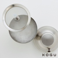 日製18-8不鏽鋼咖啡拿鐵奶泡用雪克杯，含細緻濾網蓋和裝有白色奶泡的杯身，整體為銀色金屬質感。