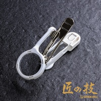 白色塑膠外殼的不鏽鋼指甲剪，帶有一個圓形放大鏡。