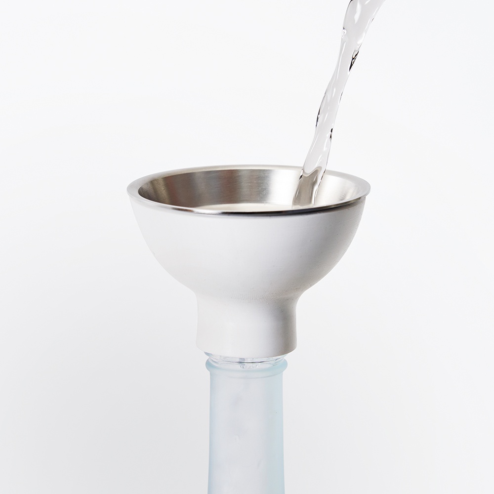 日製漏斗組，白色外層搭配銀色不鏽鋼內緣，正將液體倒入玻璃瓶中。