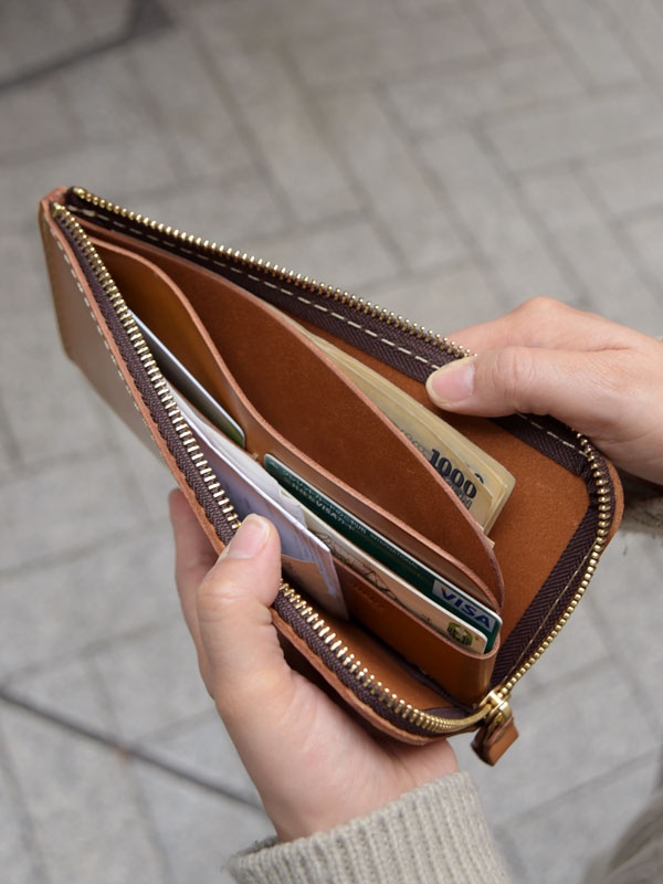 職人手作皮革L型拉鍊長夾，採用溫潤的棕色皮革，內有卡片、紙鈔。拉鍊開合設計，金色拉鍊頭，車縫線整齊。