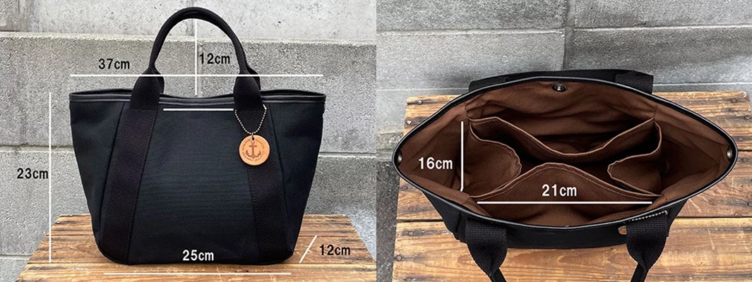 黑色帆布手提托特包，配有兩個提把、一個圓形木質吊飾，內部有三個分隔口袋。尺寸標示：整體高度23公分，底部寬度25公分，提把高度12公分，內部口袋高度16公分，內部口袋寬度21公分。