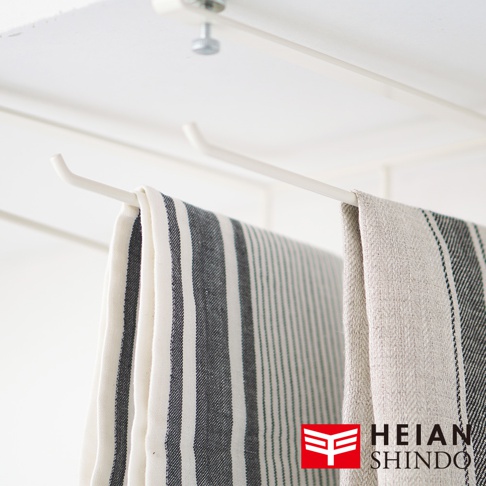 白色金屬製免鑽櫥櫃毛巾架，懸掛兩條條紋毛巾，一條為寬條紋，另一條為細條紋。