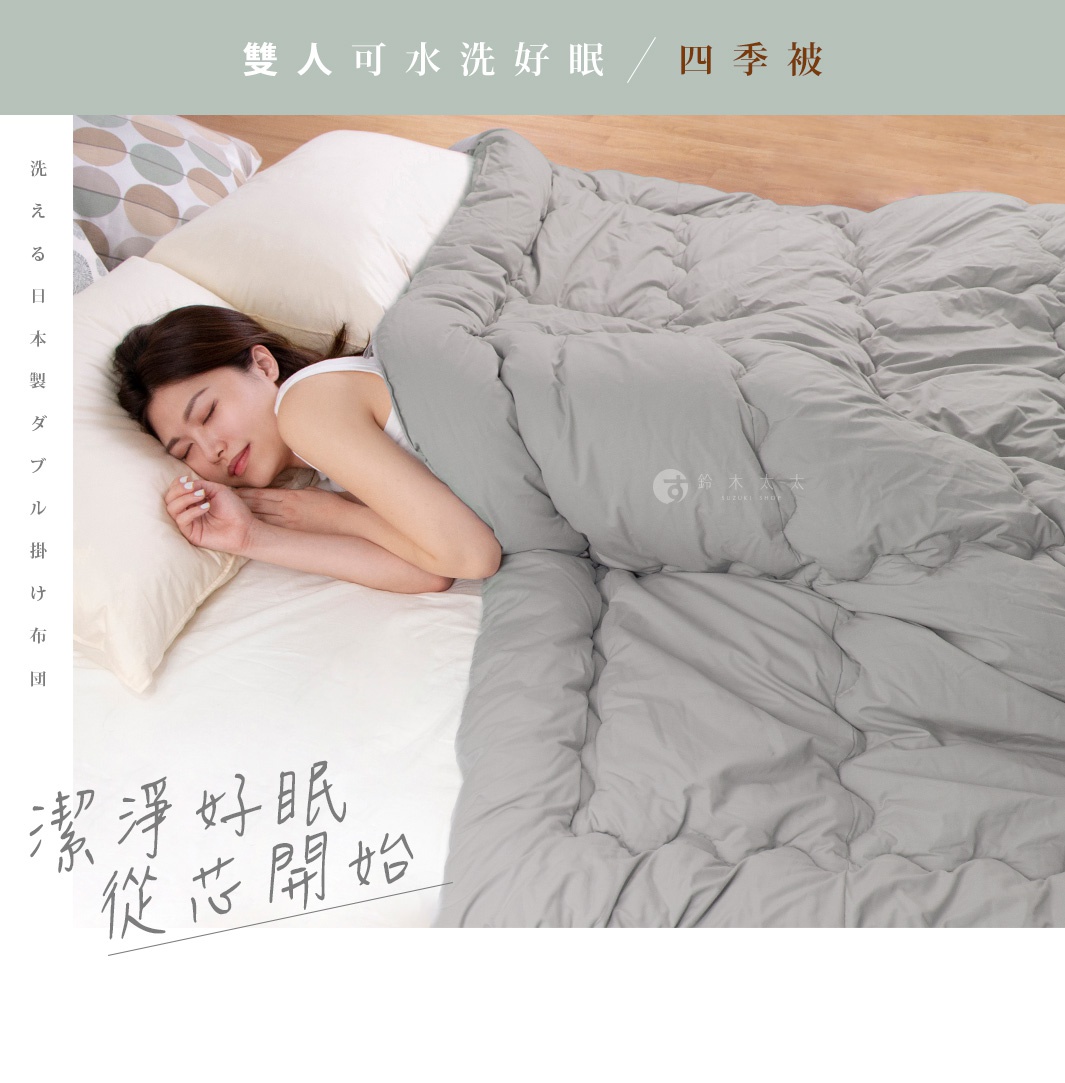 一位女子安睡於床上，身上蓋著一件灰色雙人可水洗四季被，被子填充物為中棉0.8kg。