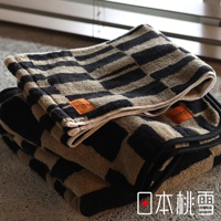 堆疊的格紋毛巾，上面有 ORIRIE 品牌標籤，左下角有日文「日本桃雪」標識