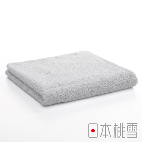 一條淺灰色飯店毛巾，材質柔軟，呈現蓬鬆的絨毛感，折疊整齊，背景為純白色。