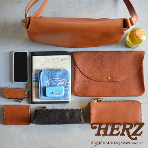 一組皮革製的隨身斜背包、手機、筆記本、手帕、薄荷糖盒、鑰匙包、零錢包、長夾，以及一個印有HERZ字樣的長夾。