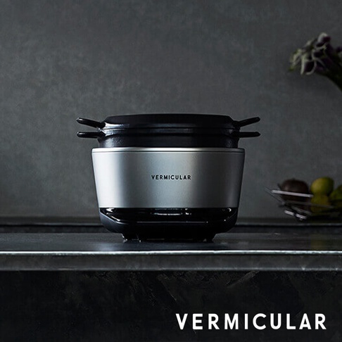 銀色 Vermicular mini IH 琺瑯電子鑄鐵鍋，配有黑色鍋蓋和提把，放置於深色檯面上。