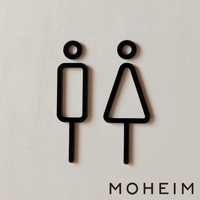 一對黑色簡約男女廁所標示牌，分別為男性（矩形身體）和女性（三角形身體）圖案，皆有圓形頭部和長形腿部，立體設計，材質疑似為壓克力或木材，背景為淺色紋理表面。