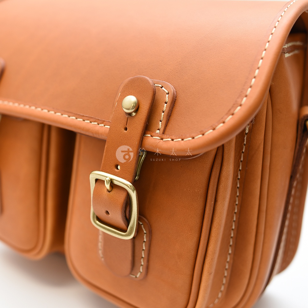 日本製HERZ職人手作皮革經典雙扣郵差包，棕色皮革搭配黃銅釦飾，精緻縫線展現職人手工質感。