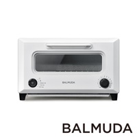 白色 ReBaker 烤麵包機，配有銀色提把、黑色旋鈕和玻璃視窗，機身印有 BALMUDA 品牌標誌。