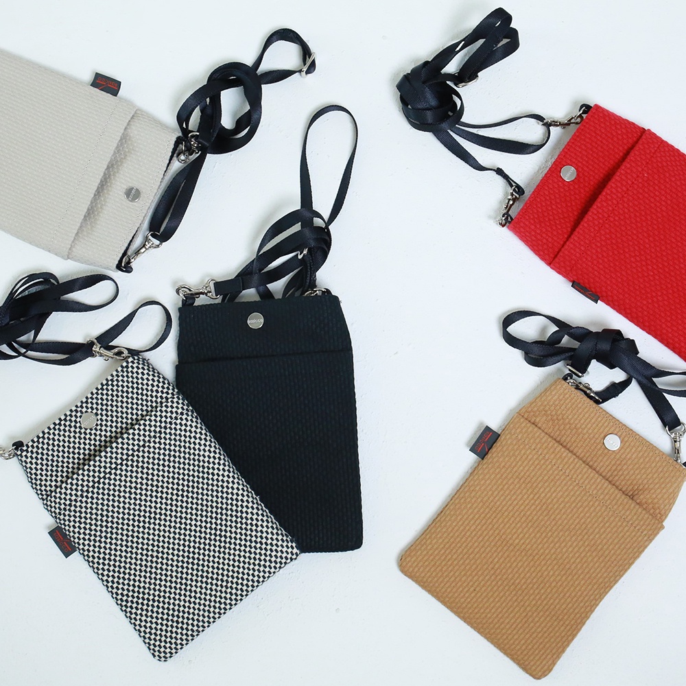 五款三河木綿刺子織手機包：米白色、紅、黑、千鳥格紋、卡其色，皆配有黑色斜背帶與金屬扣環。