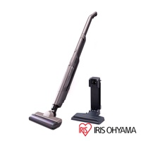 深灰色充電式輕巧多功能吸塵器，帶有黑色充電座。吸塵器主體為細長形，配備寬大的吸頭，吸頭上有紫色滾輪。