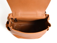 職人手作皮革屋瓦風經典雙扣後背包，採用天然棕褐色皮革，結構清晰，內裡空間寬敞，細節處以黃銅色五金件點綴。