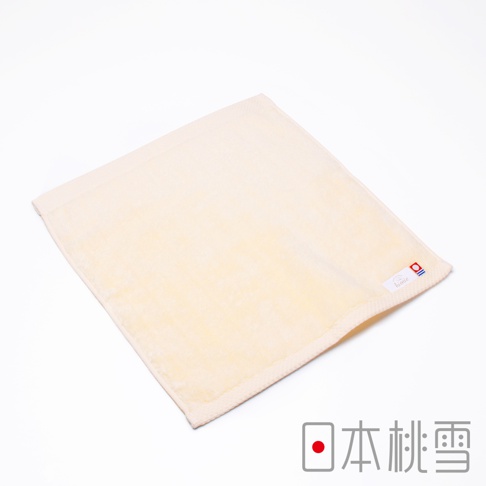 今治超長棉方巾，淺黃色，材質為柔軟吸水的棉，帶有細緻的紋理，右下角有品牌標誌。