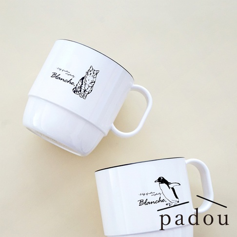 兩個白色陶瓷馬克杯放置在淺色背景上，上方馬克杯印有貓咪圖案及Blanche字樣，下方馬克杯則印有企鵝圖案及Blanche字樣，右下角標有PADOU品牌名稱。
