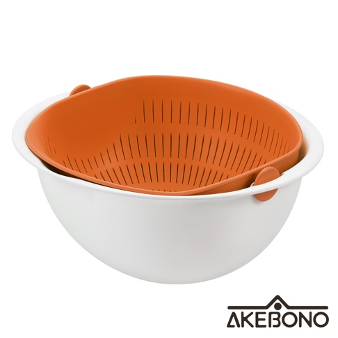 白色外盆內置橘色網狀瀝水籃，籃身有多條狹長濾孔，兩側有橘色提把，設計簡潔實用。
