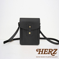 職人手作皮革散步包，黑色，附斜挎肩帶，包身有雙重縫線設計，正面有翻蓋與兩顆黃銅色金屬釦。