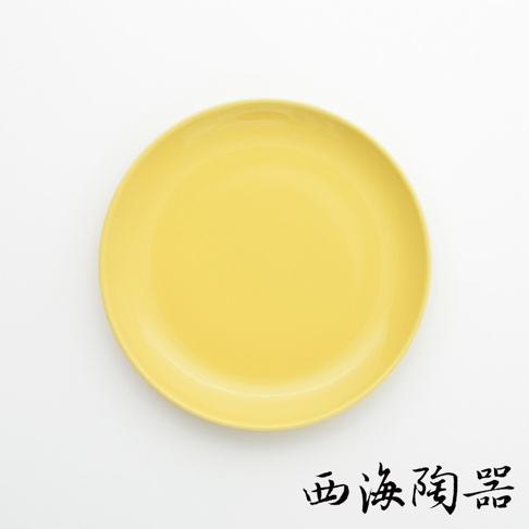 一個18公分的波佐見燒Common陶瓷料理盤，顏色為亮黃色，盤面平滑，邊緣有微微的弧度。