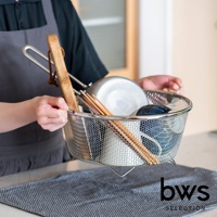 一個裝有碗盤和筷子的不鏽鋼圓形網狀瀝水籃，籃子帶有提把，由細密的銀色金屬網製成，底部有支架。